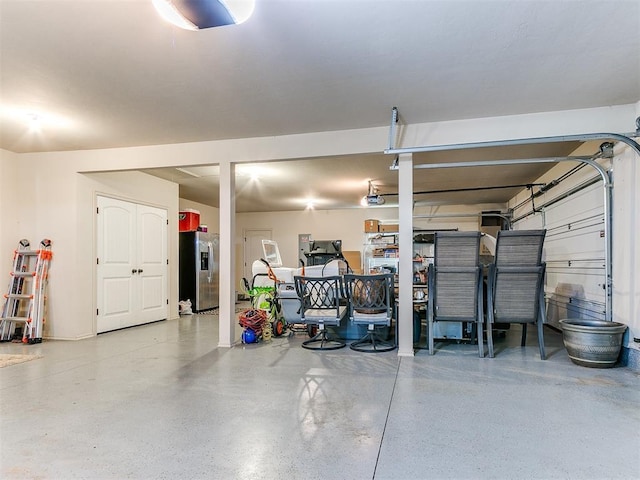 13512 SE 95th St, Oklahoma City, OK 73165 - garage with stainless steel fridge with ice dispenser and a garage door opener