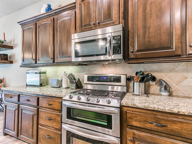 13512 SE 95th St, Oklahoma City, OK 73165 - kitchen featuring stainless steel appliances, open shelves, decorative backsplash, light stone counters, and dark brown cabinets