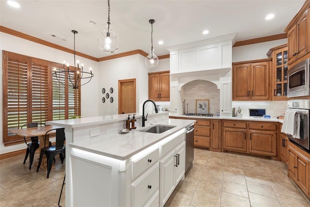 1900 Cobblestone Dr, Shawnee, OK 74804 - kitchen with stainless steel appliances, tasteful backsplash, an island with sink, crown molding, and brown cabinetry