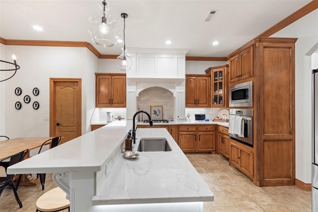 1900 Cobblestone Dr, Shawnee, OK 74804 - kitchen featuring appliances with stainless steel finishes, tasteful backsplash, crown molding, brown cabinets, and recessed lighting