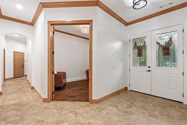 1900 Cobblestone Dr, Shawnee, OK 74804 - entrance foyer with crown molding, arched walkways, light tile patterned floors, and recessed lighting