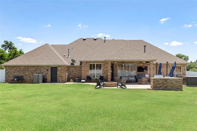 1900 Cobblestone Dr, Shawnee, OK 74804 - back of property with a yard, a patio, brick siding, ceiling fan, and roof with shingles