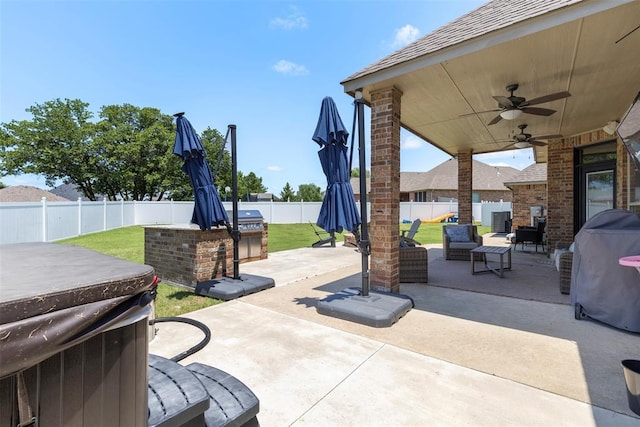 1900 Cobblestone Dr, Shawnee, OK 74804 - fenced backyard featuring a patio, a ceiling fan, exterior kitchen, a hot tub, and an outdoor living space