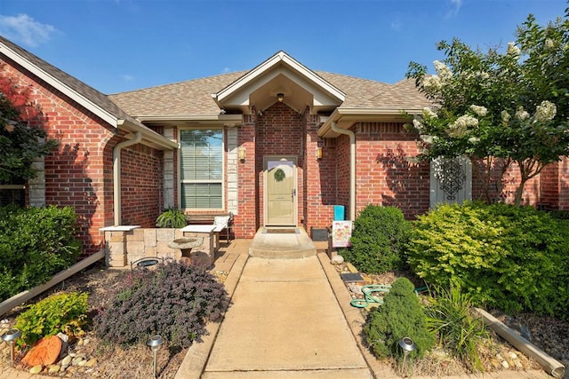 2329 Chase Way, Yukon, OK 73099 - property entrance featuring brick siding and roof with shingles