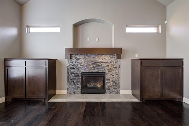 2329 Chase Way, Yukon, OK 73099 - unfurnished living room featuring dark wood-style floors, a tile fireplace, and high vaulted ceiling