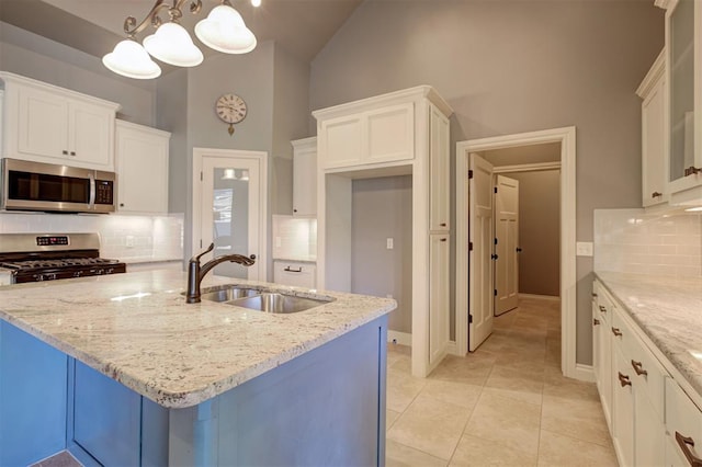 2329 Chase Way, Yukon, OK 73099 - kitchen featuring stainless steel appliances, backsplash, light stone counters, high vaulted ceiling, and white cabinets