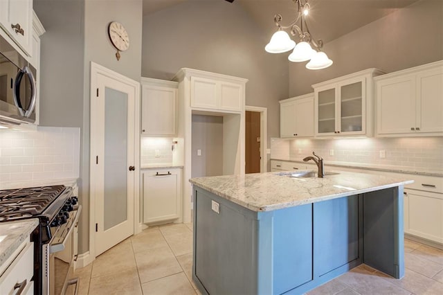 2329 Chase Way, Yukon, OK 73099 - kitchen with stainless steel appliances, decorative backsplash, light stone countertops, white cabinets, and light tile patterned flooring