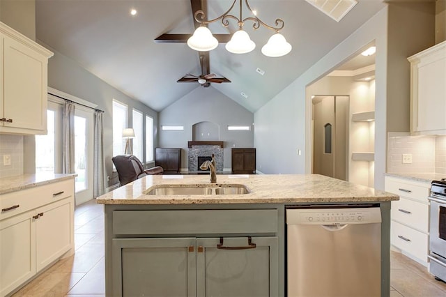 2329 Chase Way, Yukon, OK 73099 - kitchen featuring stainless steel appliances, backsplash, ceiling fan, a fireplace, and light tile patterned flooring