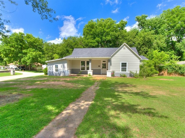 529 S 2nd Ave, Purcell, OK 73080 - ranch-style house with a porch, a front yard, and a shingled roof