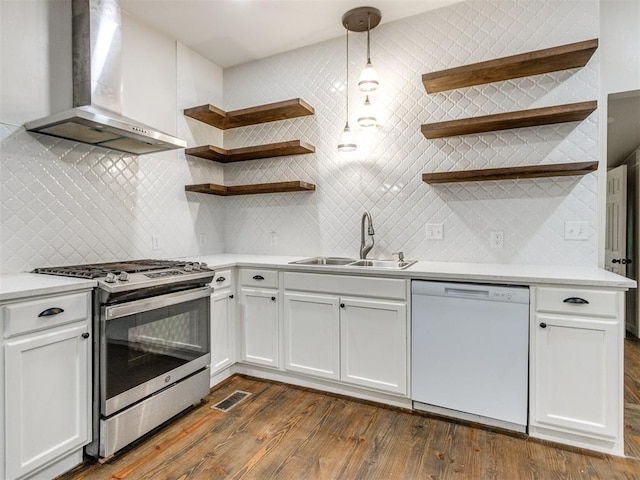 529 S 2nd Ave, Purcell, OK 73080 - kitchen with stainless steel range with gas stovetop, wall chimney range hood, dishwasher, open shelves, and dark wood-style flooring