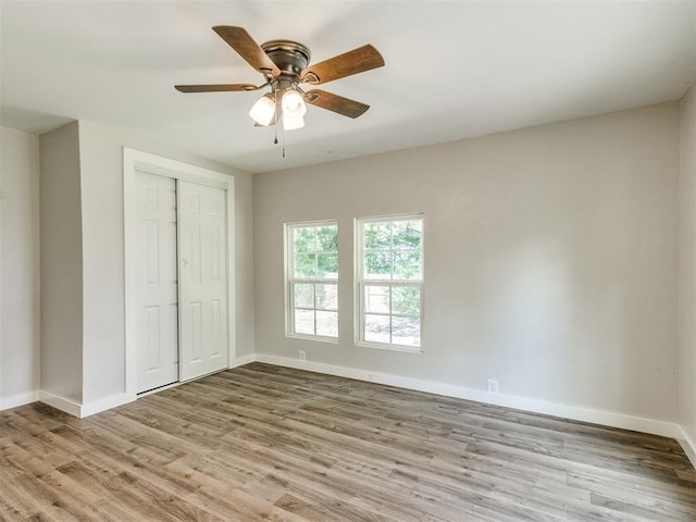 529 S 2nd Ave, Purcell, OK 73080 - unfurnished bedroom with wood finished floors, a closet, and a ceiling fan