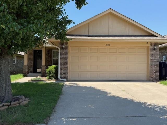 1029 Switzerland Ave, Yukon, OK 73099 - ranch-style house with a garage, concrete driveway, and brick siding