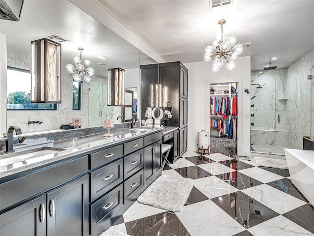 2824 Guilford Ln, Oklahoma City, OK 73120 - bathroom with a chandelier, a marble finish shower, double vanity, a spacious closet, and marble finish floors