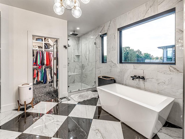 2824 Guilford Ln, Oklahoma City, OK 73120 - bathroom with a marble finish shower, a chandelier, a soaking tub, a spacious closet, and marble tiled flooring