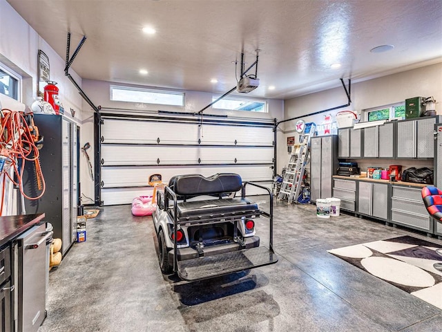 2824 Guilford Ln, Oklahoma City, OK 73120 - garage featuring a garage door opener and recessed lighting