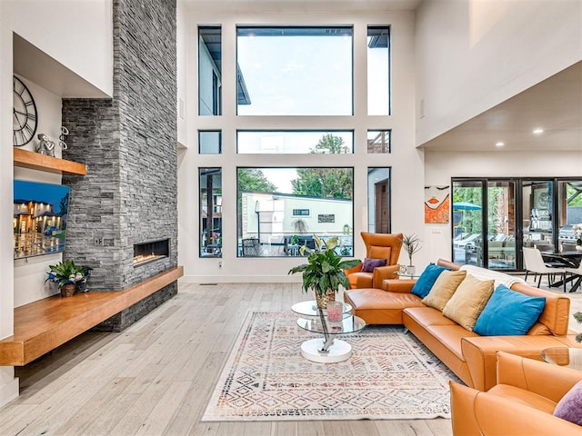 2824 Guilford Ln, Oklahoma City, OK 73120 - living room with a fireplace, light wood finished floors, and a towering ceiling