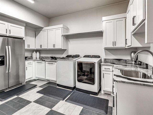 2824 Guilford Ln, Oklahoma City, OK 73120 - laundry room with washer and clothes dryer and cabinet space