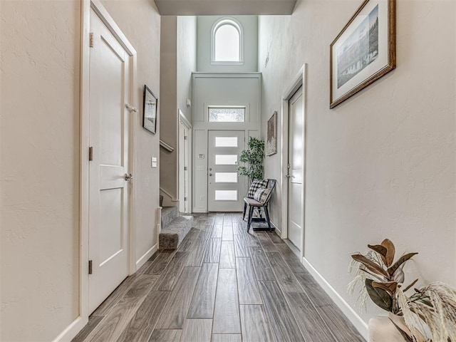 11104 Fairways Ave, Yukon, OK 73099 - entrance foyer with dark wood-style floors, a towering ceiling, and a textured wall
