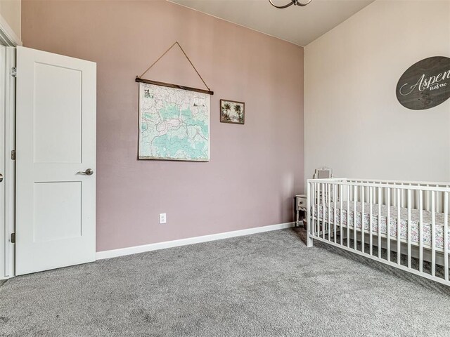 11104 Fairways Ave, Yukon, OK 73099 - carpeted bedroom with a crib and baseboards