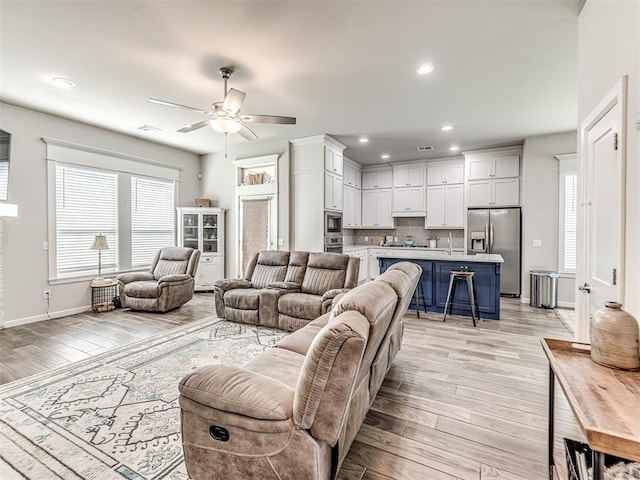 11104 Fairways Ave, Yukon, OK 73099 - living area with light wood-style floors, a ceiling fan, and recessed lighting