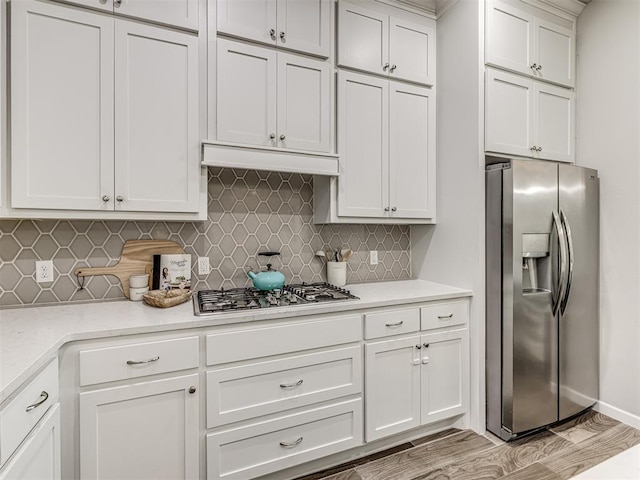 11104 Fairways Ave, Yukon, OK 73099 - kitchen with stainless steel appliances, tasteful backsplash, and white cabinets