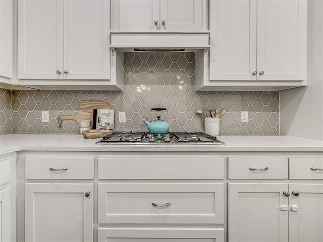11104 Fairways Ave, Yukon, OK 73099 - kitchen featuring stainless steel gas cooktop, white cabinetry, and tasteful backsplash