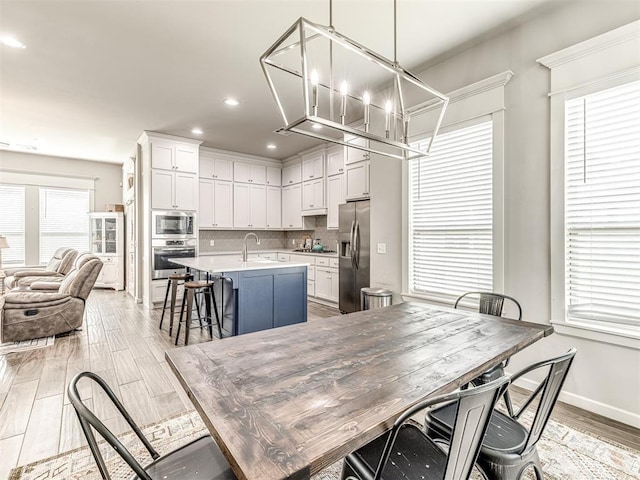 11104 Fairways Ave, Yukon, OK 73099 - dining space featuring recessed lighting, light wood finished floors, and a chandelier