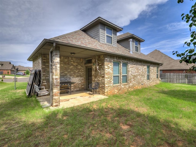 11104 Fairways Ave, Yukon, OK 73099 - back of house with a patio area, brick siding, and a shingled roof
