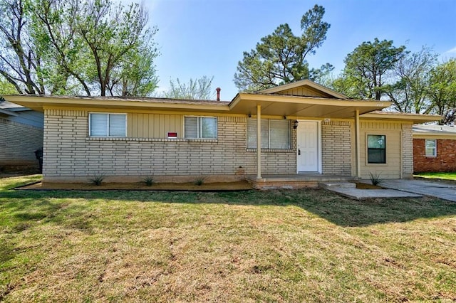 1409 Mcdonald Dr, Midwest City, OK 73130 - ranch-style home with brick siding and a front lawn