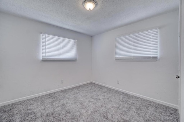 1409 Mcdonald Dr, Midwest City, OK 73130 - carpeted empty room featuring a textured ceiling and baseboards