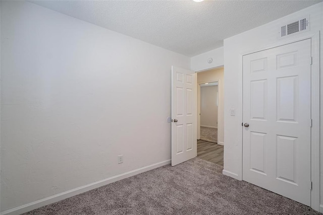 1409 Mcdonald Dr, Midwest City, OK 73130 - unfurnished bedroom featuring carpet flooring and a textured ceiling