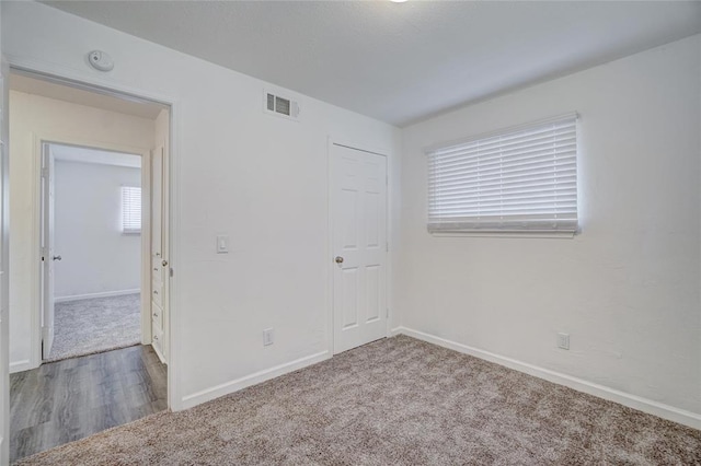 1409 Mcdonald Dr, Midwest City, OK 73130 - unfurnished bedroom featuring carpet flooring and baseboards
