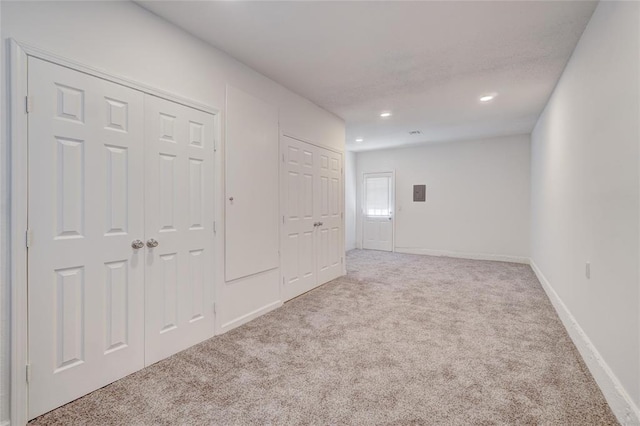 1409 Mcdonald Dr, Midwest City, OK 73130 - unfurnished bedroom featuring carpet floors, two closets, and recessed lighting