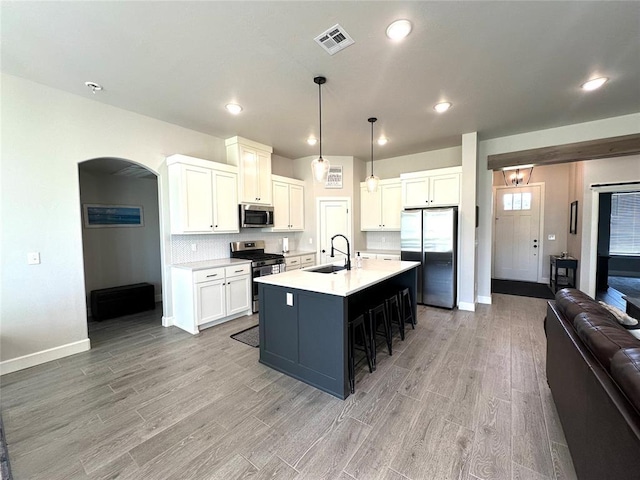 5557 Coker Rd, Shawnee, OK 74804 - kitchen featuring stainless steel appliances, open floor plan, light wood-type flooring, light countertops, and recessed lighting