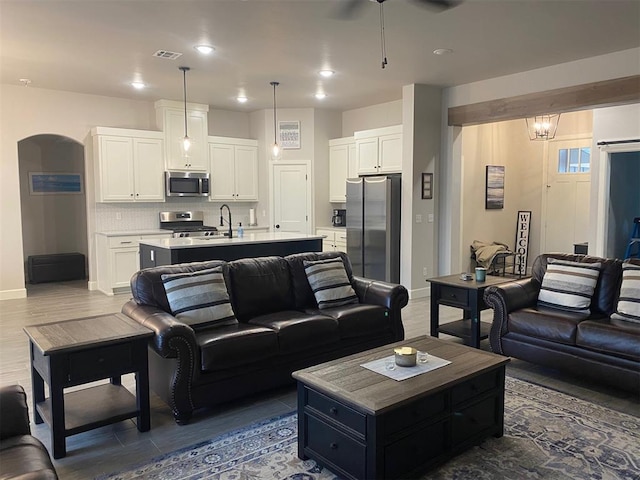 5557 Coker Rd, Shawnee, OK 74804 - living room with arched walkways, a ceiling fan, recessed lighting, and dark wood finished floors