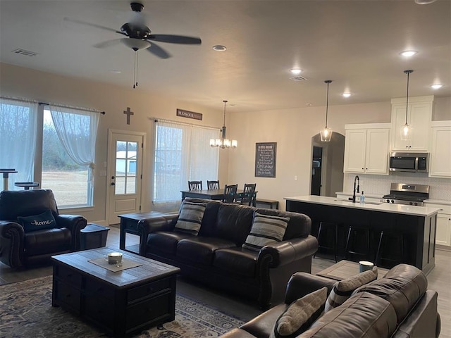 5557 Coker Rd, Shawnee, OK 74804 - living room featuring ceiling fan, a chandelier, and recessed lighting