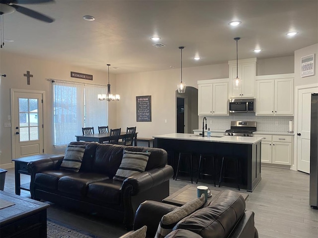 5557 Coker Rd, Shawnee, OK 74804 - living room with light wood-style floors, ceiling fan, a chandelier, and recessed lighting