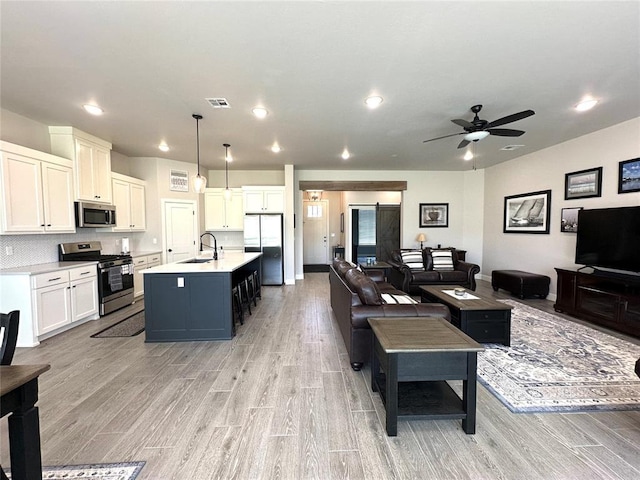 5557 Coker Rd, Shawnee, OK 74804 - living area featuring light wood-style flooring, ceiling fan, and recessed lighting