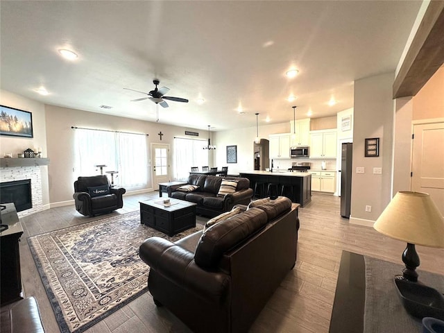 5557 Coker Rd, Shawnee, OK 74804 - living room featuring a ceiling fan, wood finished floors, a fireplace, and recessed lighting