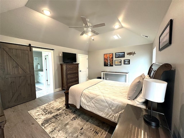 5557 Coker Rd, Shawnee, OK 74804 - bedroom featuring lofted ceiling, wood finished floors, a ceiling fan, and a barn door