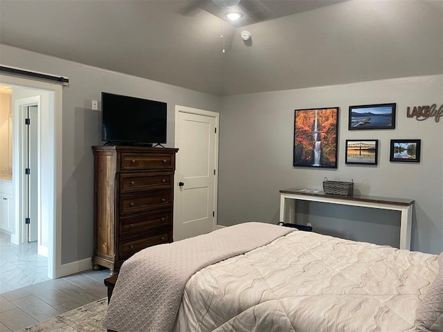 5557 Coker Rd, Shawnee, OK 74804 - bedroom with a barn door and ceiling fan