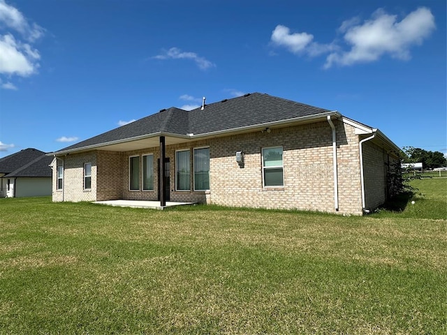 5557 Coker Rd, Shawnee, OK 74804 - back of house featuring a yard, a patio, and brick siding