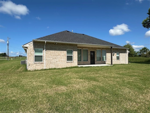 5557 Coker Rd, Shawnee, OK 74804 - back of property with a yard, brick siding, and a shingled roof