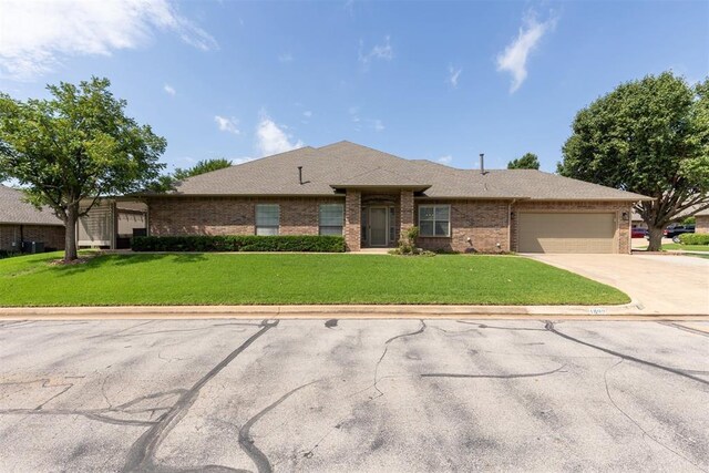 1800 NW 161st Pl, Edmond, OK 73013 - view of front of property featuring brick siding, a garage, a front yard, and driveway