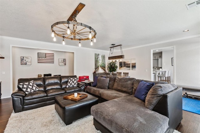 1800 NW 161st Pl, Edmond, OK 73013 - living area with wood finished floors, ornamental molding, a chandelier, and recessed lighting