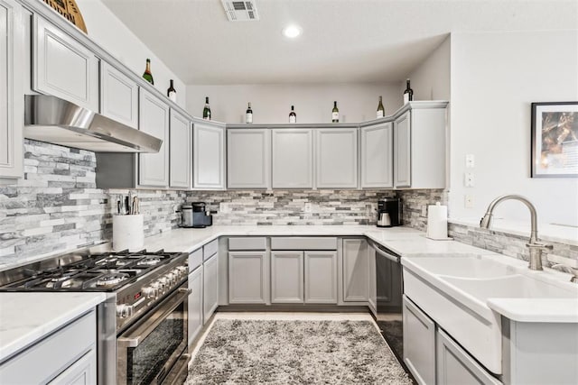 1800 NW 161st Pl, Edmond, OK 73013 - kitchen featuring stainless steel appliances, ventilation hood, tasteful backsplash, gray cabinetry, and recessed lighting