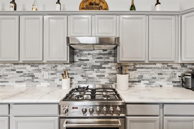 1800 NW 161st Pl, Edmond, OK 73013 - kitchen with stainless steel range with gas cooktop, under cabinet range hood, and decorative backsplash