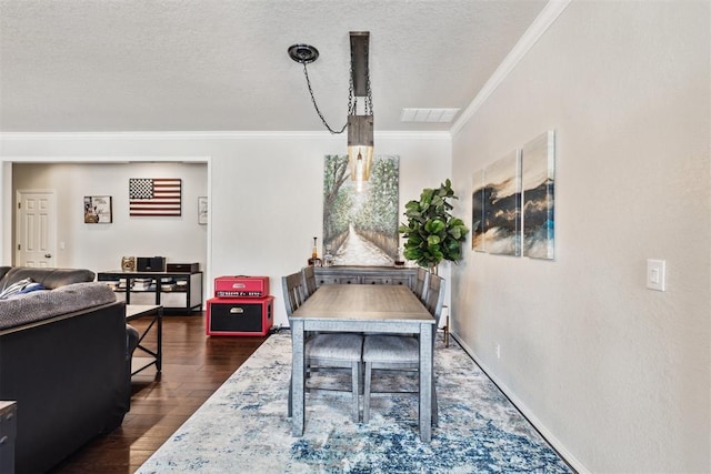 1800 NW 161st Pl, Edmond, OK 73013 - dining area featuring ornamental molding, dark wood-style floors, and a textured ceiling
