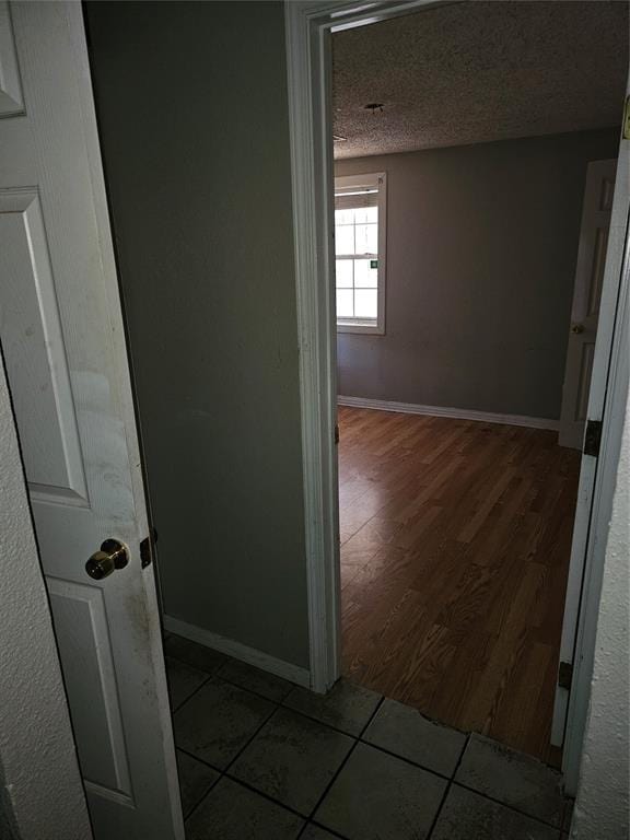 1137 Mallard Dr, Del City, OK 73115 - corridor featuring wood finished floors and a textured ceiling