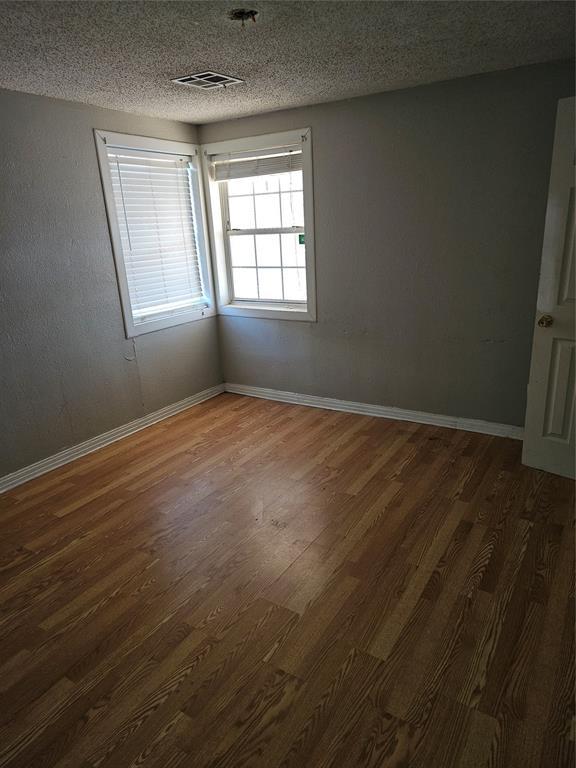 1137 Mallard Dr, Del City, OK 73115 - unfurnished room with wood finished floors and a textured ceiling